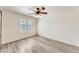 Bright bedroom with laminate flooring, a ceiling fan, and plantation shutters at 15412 N 160Th Ln, Surprise, AZ 85374