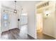 Inviting entryway featuring wood-look floors, neutral walls, and a stylish pendant light fixture at 15412 N 160Th Ln, Surprise, AZ 85374