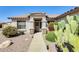 Close-up of home's entrance surrounded by desert landscaping and native cacti creating a welcoming view at 15412 N 160Th Ln, Surprise, AZ 85374