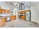 Spacious kitchen with stainless steel appliances, stylish light fixture and wooden cabinets at 15412 N 160Th Ln, Surprise, AZ 85374