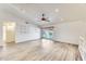 Bright living room with vaulted ceiling, laminate flooring, recessed lighting, and sliding glass doors to the backyard at 15412 N 160Th Ln, Surprise, AZ 85374