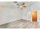 Spacious main bedroom featuring laminate flooring, a ceiling fan, recessed lighting and hallway with wood cabinetry at 15412 N 160Th Ln, Surprise, AZ 85374