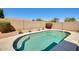 Inviting pool area featuring lush landscaping, privacy fence, and desert plants at 15412 N 160Th Ln, Surprise, AZ 85374