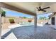 Covered patio overlooking a refreshing pool with lush landscaping and privacy fence at 15412 N 160Th Ln, Surprise, AZ 85374