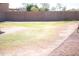 Large, private backyard featuring grass and desert landscaping, along with a walled perimeter at 16120 W Kendall St, Goodyear, AZ 85338