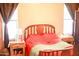 Cozy bedroom with wooden headboard, bright windows, and side tables at 16120 W Kendall St, Goodyear, AZ 85338