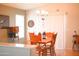 Bright dining area with a pendant chandelier and a table seating four, bathed in natural light at 16120 W Kendall St, Goodyear, AZ 85338