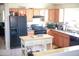 Kitchen featuring modern appliances and an island, perfect for cooking at 16120 W Kendall St, Goodyear, AZ 85338