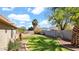 Lush backyard with lawn, landscaping and privacy block fence at 1633 W Andorra Dr, Phoenix, AZ 85029