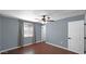 Bright bedroom with light gray paint, a ceiling fan, and wood-look floors at 1633 W Andorra Dr, Phoenix, AZ 85029
