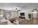 A furnished living room with tile floors, neutral walls, ceiling fan, and bright natural light offers a move-in-ready space at 1633 W Andorra Dr, Phoenix, AZ 85029