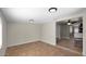 Spacious living area featuring tiled floors, neutral walls, and access to the kitchen at 1633 W Andorra Dr, Phoenix, AZ 85029