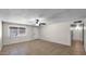 Expansive living room with tile flooring, neutral paint, fan, and natural light provides a bright, welcoming atmosphere at 1633 W Andorra Dr, Phoenix, AZ 85029