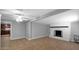 Large, tiled living room featuring a fireplace and access to the kitchen at 1633 W Andorra Dr, Phoenix, AZ 85029