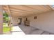 This covered patio boasts a sliding glass door, a storage shelf, and seamless indoor-outdoor flow at 1633 W Andorra Dr, Phoenix, AZ 85029