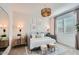 A secondary bedroom is staged as a sitting room with a comfortable daybed and a stylish wooden drum light fixture at 16694 W Audrey Ln, Surprise, AZ 85387