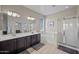 Bathroom featuring a shower, bathtub, double vanity, and neutral tile flooring at 1785 S Morrison Ln, Gilbert, AZ 85295