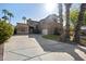 Spacious home featuring a large driveway, well-manicured lawn and mature palm trees at 1785 S Morrison Ln, Gilbert, AZ 85295