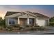Charming single-story home with a stone-accented front porch and attached two-car garage at 19072 E Caledonia Dr, Queen Creek, AZ 85142