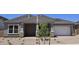 Charming single-Gathering home with desert landscaping, covered porch, and attached two-car garage at 19072 E Caledonia Dr, Queen Creek, AZ 85142