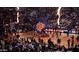 Energetic basketball game with performers, fans, and a large Suns flag, creating an exciting atmosphere at 2323 N Central Ave # Ph-C, Phoenix, AZ 85004