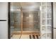 Bathroom featuring natural stone and a glass shower with intricate stonework at 2323 N Central Ave # Ph-C, Phoenix, AZ 85004