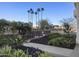 Beautiful courtyard landscaping features lush greenery, palms, and vibrant flowering plants at 2323 N Central Ave # Ph-C, Phoenix, AZ 85004