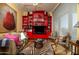 Living room with bold red shelving, unique decor, and comfortable seating at 2323 N Central Ave # Ph-C, Phoenix, AZ 85004