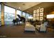 Lounge area with a piano, patterned chairs, and large windows at 2323 N Central Ave # Ph-C, Phoenix, AZ 85004