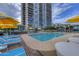Relaxing pool area with loungers, umbrellas and high-rise in the background at 2323 N Central Ave # Ph-C, Phoenix, AZ 85004