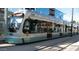 Modern light rail train displaying route number 134B on a sunny day in a metropolitan area at 2323 N Central Ave # Ph-C, Phoenix, AZ 85004
