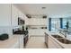Well-equipped kitchen with white cabinets, stainless steel appliances, and a view to the outdoor space at 24973 N 174Th Ave, Surprise, AZ 85387