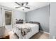 Bedroom with a ceiling fan, and a white bed with a patterned comforter at 25844 W Watkins St, Buckeye, AZ 85326