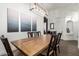 Elegant dining room with a modern chandelier, wooden table, and stylish decor at 25844 W Watkins St, Buckeye, AZ 85326