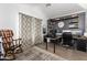 Home office featuring an office chair, a desk, and black and gray walls at 25844 W Watkins St, Buckeye, AZ 85326