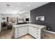 Bright kitchen features granite counters, white cabinets, hardwood floors, and modern appliances; adjoins a living area at 25844 W Watkins St, Buckeye, AZ 85326