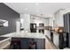 Bright kitchen features granite counters, white cabinets, modern black appliances, hardwood floors and an island at 25844 W Watkins St, Buckeye, AZ 85326