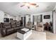 Open-concept living room featuring hardwood floors, comfortable seating, and abundant natural light at 25844 W Watkins St, Buckeye, AZ 85326