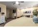 Spacious carpeted main bedroom with a ceiling fan, seating area, modern furniture, and natural light at 25844 W Watkins St, Buckeye, AZ 85326