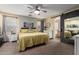 Spacious main bedroom features a ceiling fan, carpet, natural light, and en-suite bathroom access at 25844 W Watkins St, Buckeye, AZ 85326