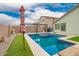 Backyard pool with clear blue water, desert landscaping, and shaded lounge area, great for entertaining at 25844 W Watkins St, Buckeye, AZ 85326