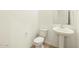 A half bathroom offering a pedestal sink, tile floor, and modern fixtures in a minimalist design at 2639 E Santa Ynez Dr, Casa Grande, AZ 85194