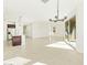 Open-concept living area with tile floors, kitchen island, and sliding glass doors at 2639 E Santa Ynez Dr, Casa Grande, AZ 85194