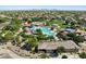 Aerial view of a community pool with waterslides, a park, and neighborhood scenery, surrounded by lush landscaping at 2639 E Santa Ynez Dr, Casa Grande, AZ 85194