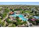 Aerial view of a community pool area featuring waterslides, splash pads, a large pool, and neighborhood scenery at 2639 E Santa Ynez Dr, Casa Grande, AZ 85194