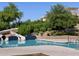 Community pool features a waterslide, lush landscaping, and a clear blue swimming area at 2639 E Santa Ynez Dr, Casa Grande, AZ 85194