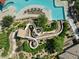 Aerial close up of the community pool waterslides and splash pad with lounge chairs and landscaping at 2639 E Santa Ynez Dr, Casa Grande, AZ 85194