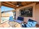 Covered patio features ceiling fans and an outdoor seating area overlooking the pool at 2810 S Emerson --, Mesa, AZ 85210