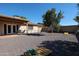 Spacious gravel backyard includes a covered patio, yard games and desert landscaping at 2810 S Emerson --, Mesa, AZ 85210