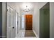 Inviting entryway with white tile flooring, a chandelier, a wooden front door and textured glass block at 2810 S Emerson --, Mesa, AZ 85210